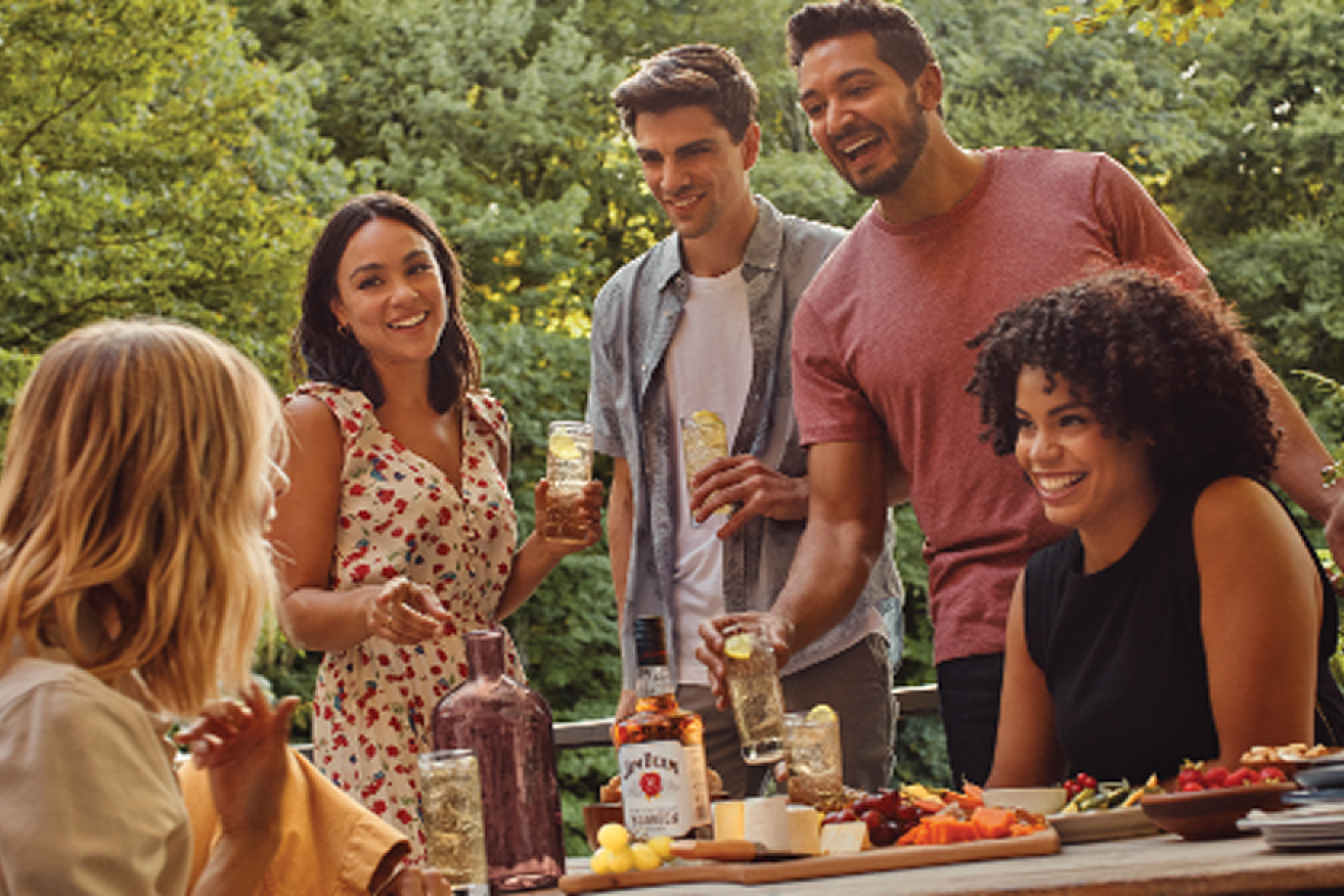 people gathered around table backyard jim beam