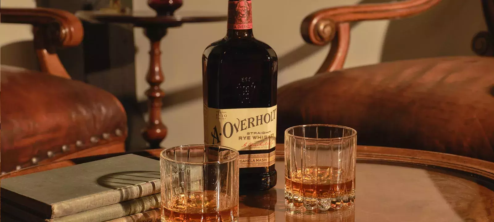 Whiskey bottle and two glasses on a table of American Rye Whiskly Monongahela Mash Old Overholt