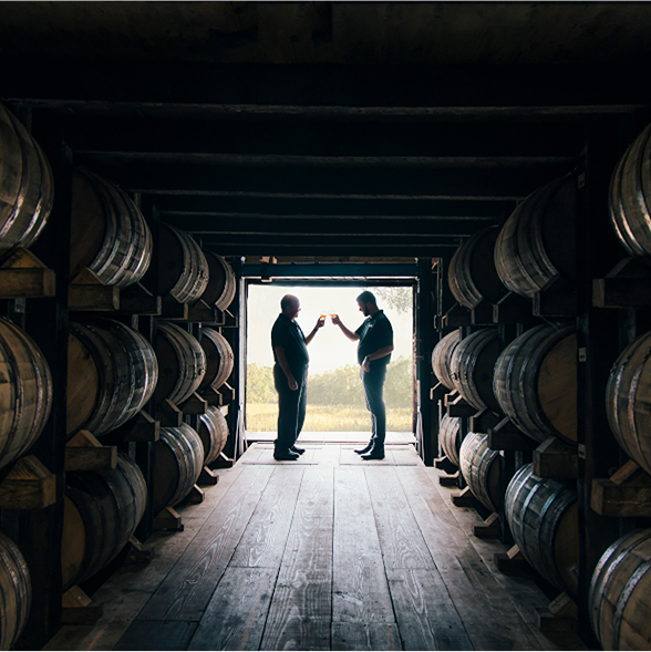 Farmer Distiller and Barrels in Distillery Whisky Old Grand-Dad 