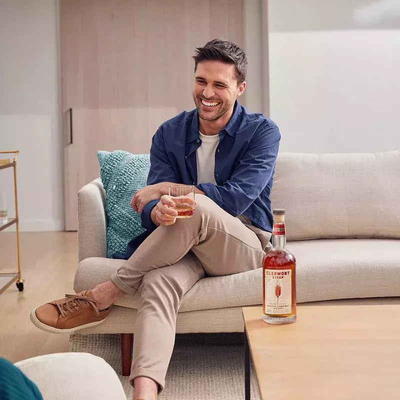 Man enjoying glass of Whisky Clermont Steep