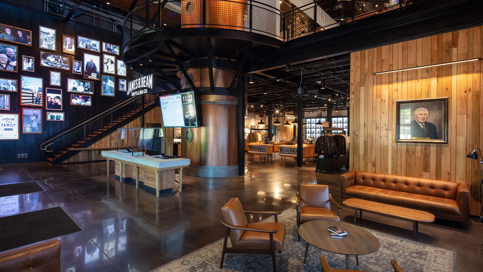 Lobby and lounge area of the American Outpost visitor center with couches and brand display cases.