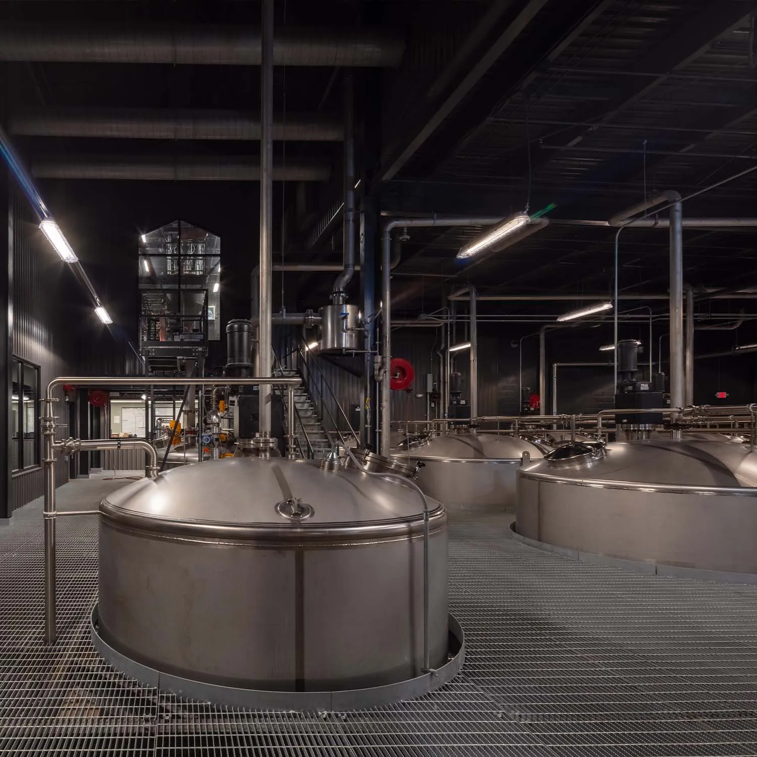 Inside the James B. Beam Distilling Co. modern fermentation room with stainless steel tanks.