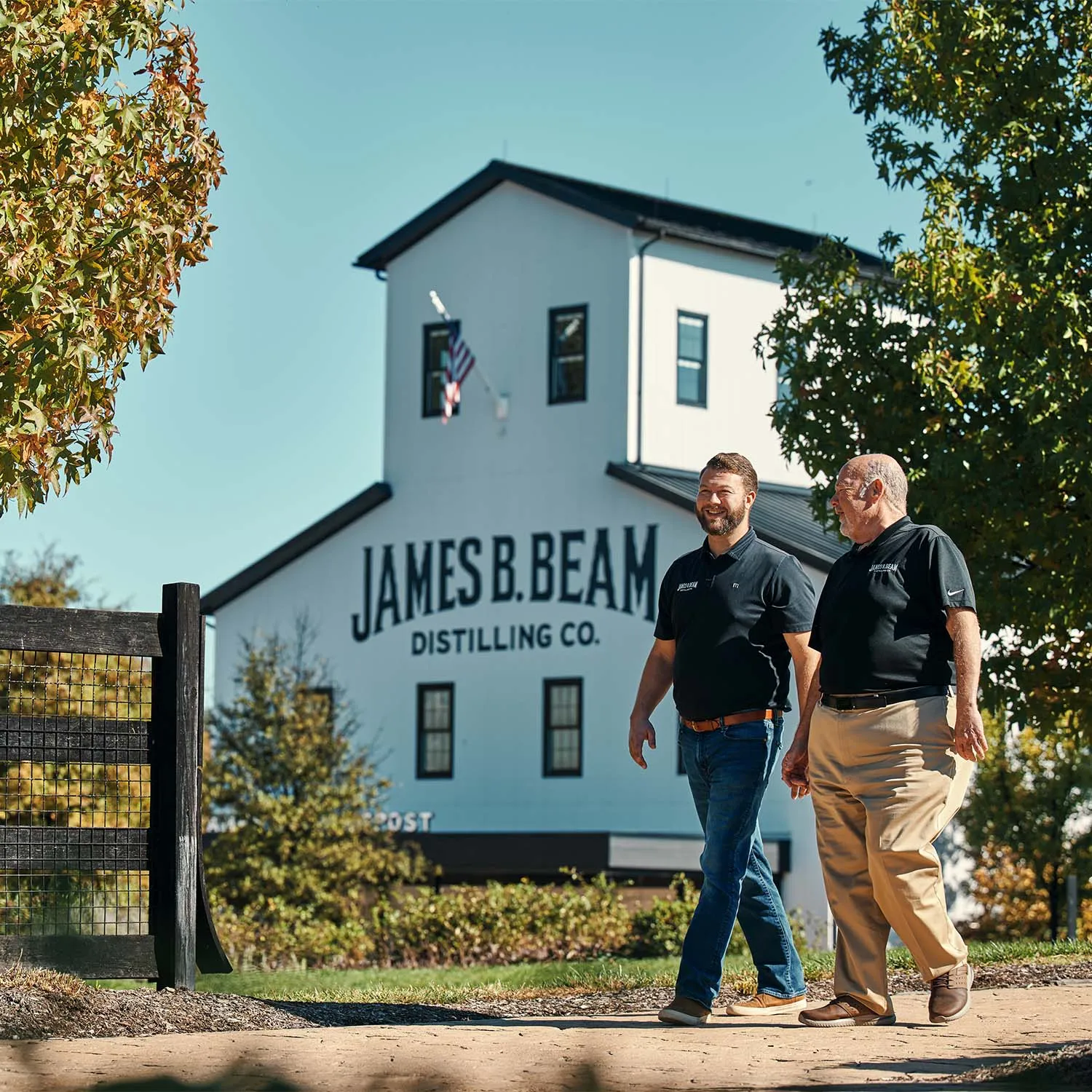 Fred and Freddie Noe walking on the James B. Beam Distilling Co. campus in front of the American Outpost.