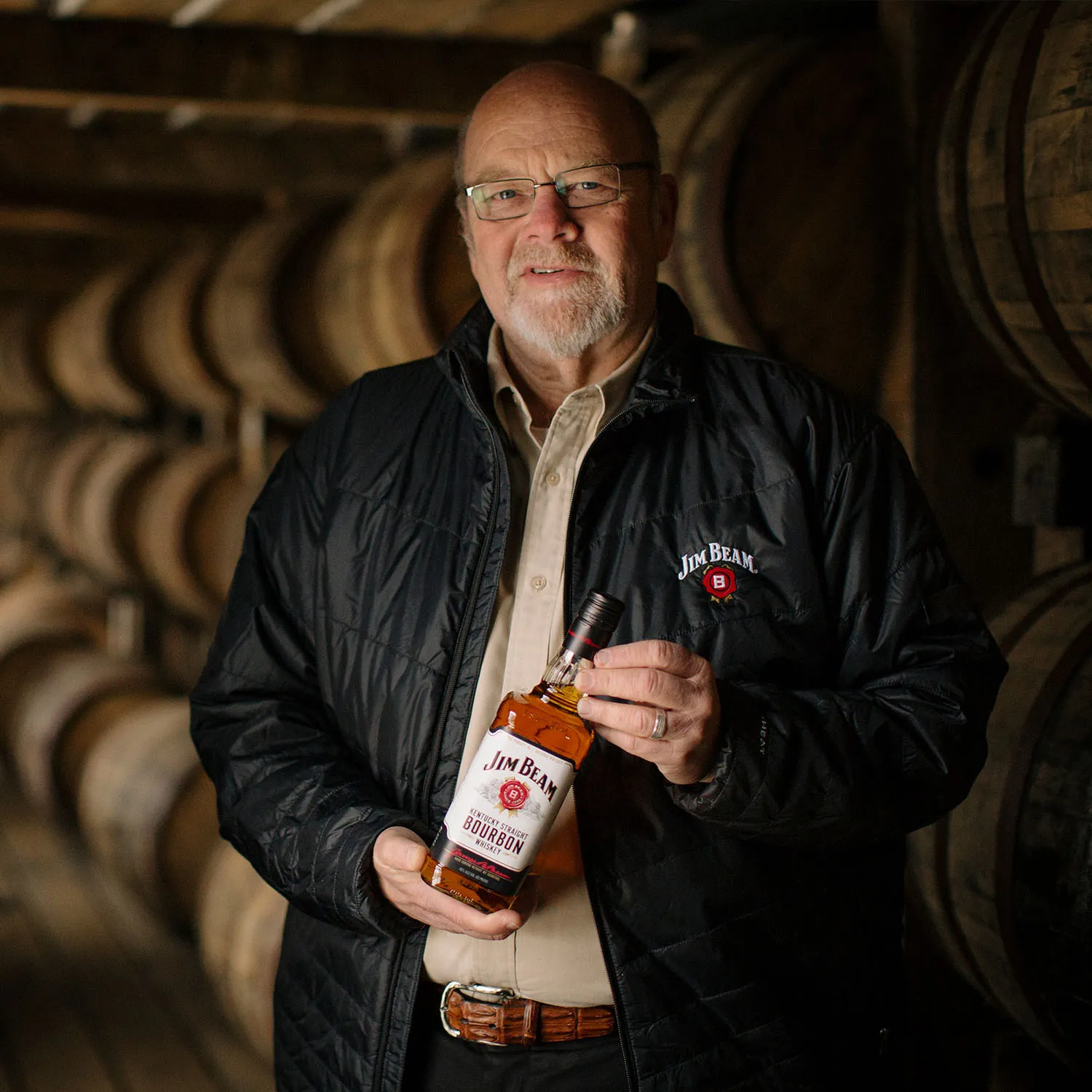 7th Generation Master Distillery Fred Noe posing with a bottle of Jim Beam in a James B. Beam Distilling Co. rackhouse