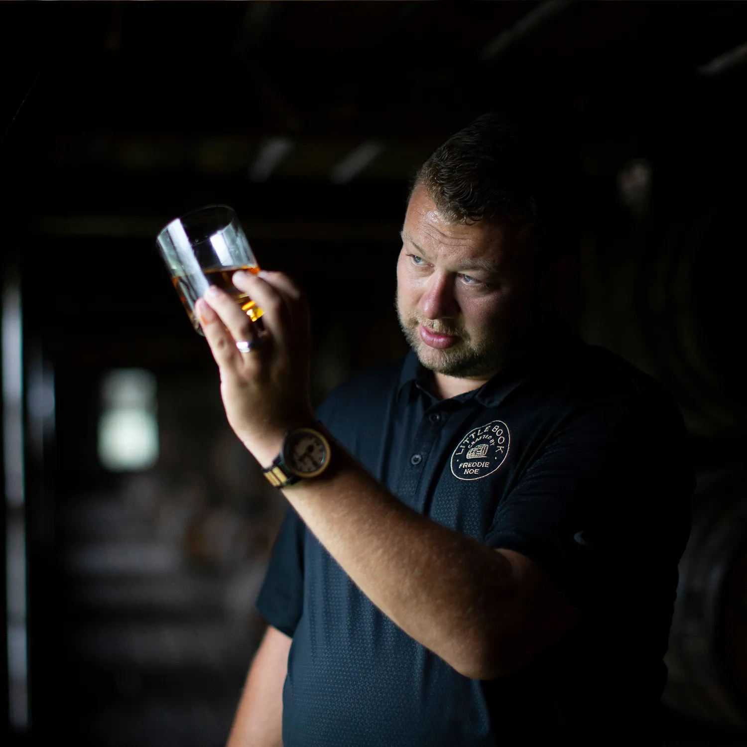 8th Generation Master Distiller Freddie Noe inspecting liquid in a James B Beam Distilling Co rackhouse
