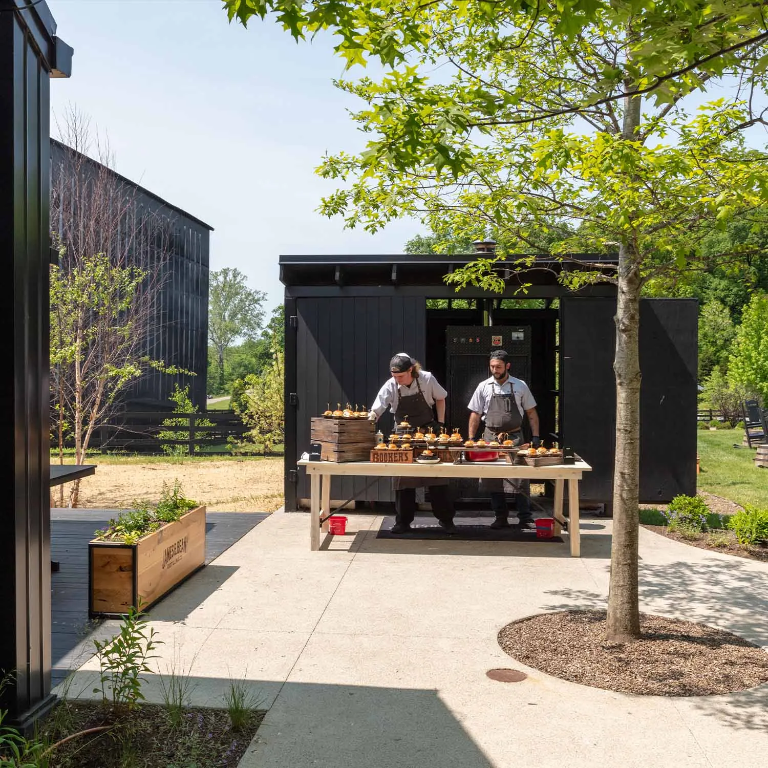 Chefs setting up food service in the outdoor area for a catered event at the James B. Beam Courtyard