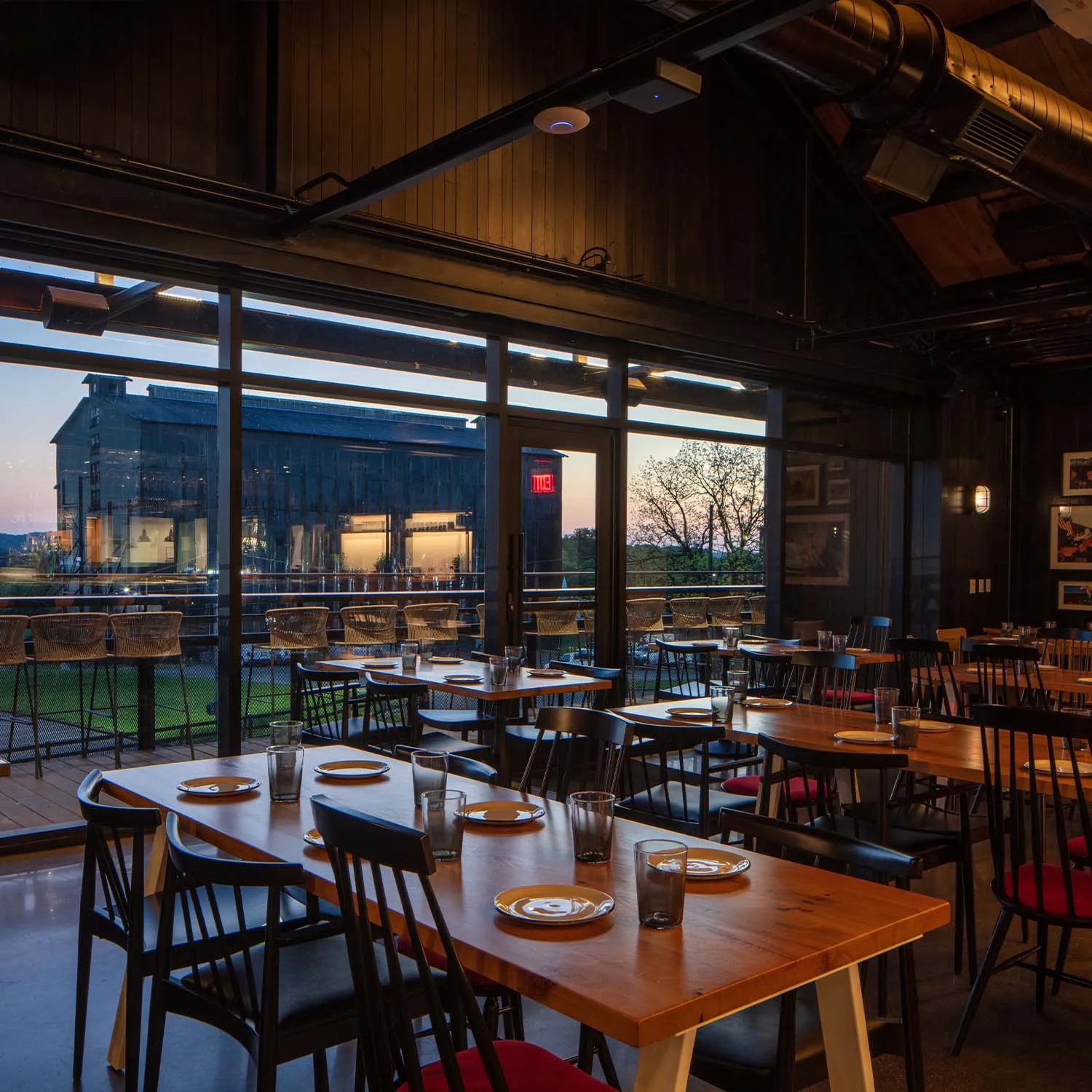 Interior dining room of The Kitchen Table with large windows overlooking the distillery grounds.