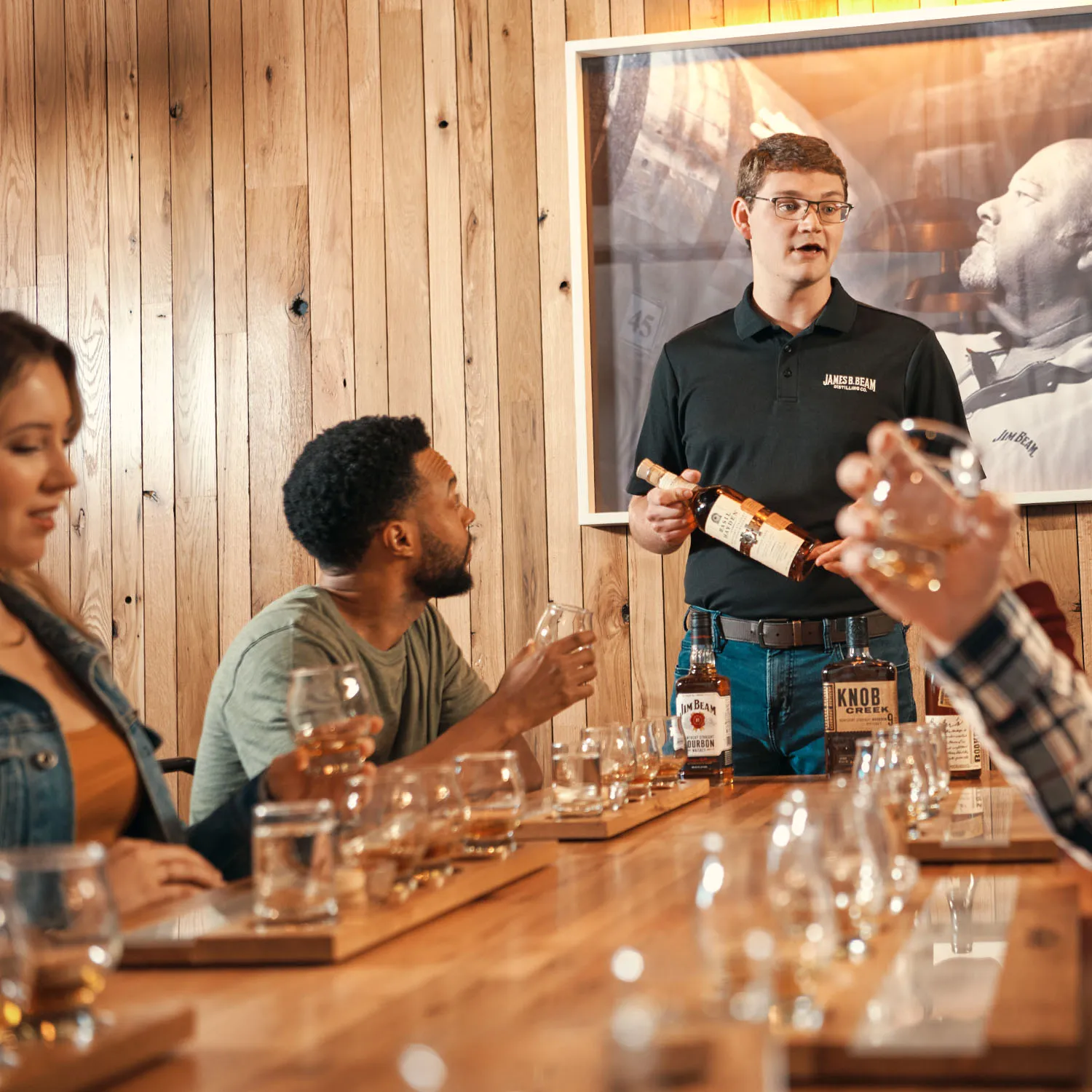 Guide holding a Basil Hayden bottle during a tasting experience at the James B. Beam Distilling Co.